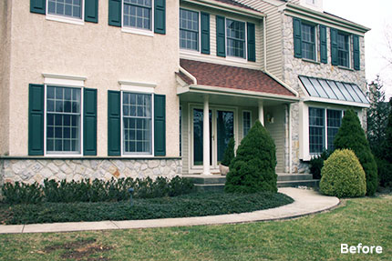 Front of the house before the GLDesigns renovation, hidden behind overgrown plantings